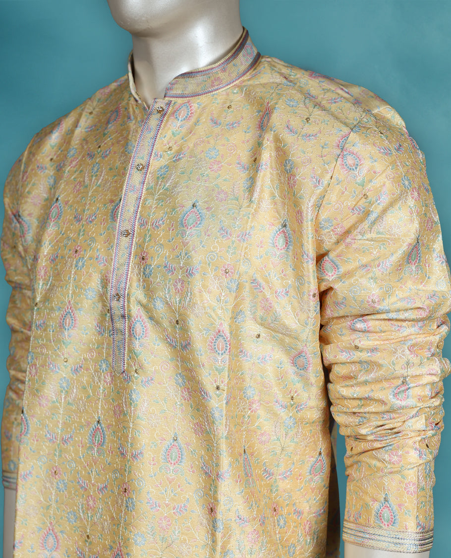 Haldi yellow colour semi silk kurta set featuring multicolour floral thread work on the body, full sleeves, and paired with a matching bottom.