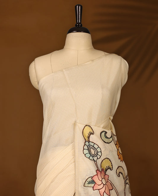 Elegant off white colour Kota net saree highlighted with vibrant hand painted motifs of peacocks and floral patterns on the pallu, blending tradition with artistic finesse & Perfect for festive and cultural occasions.