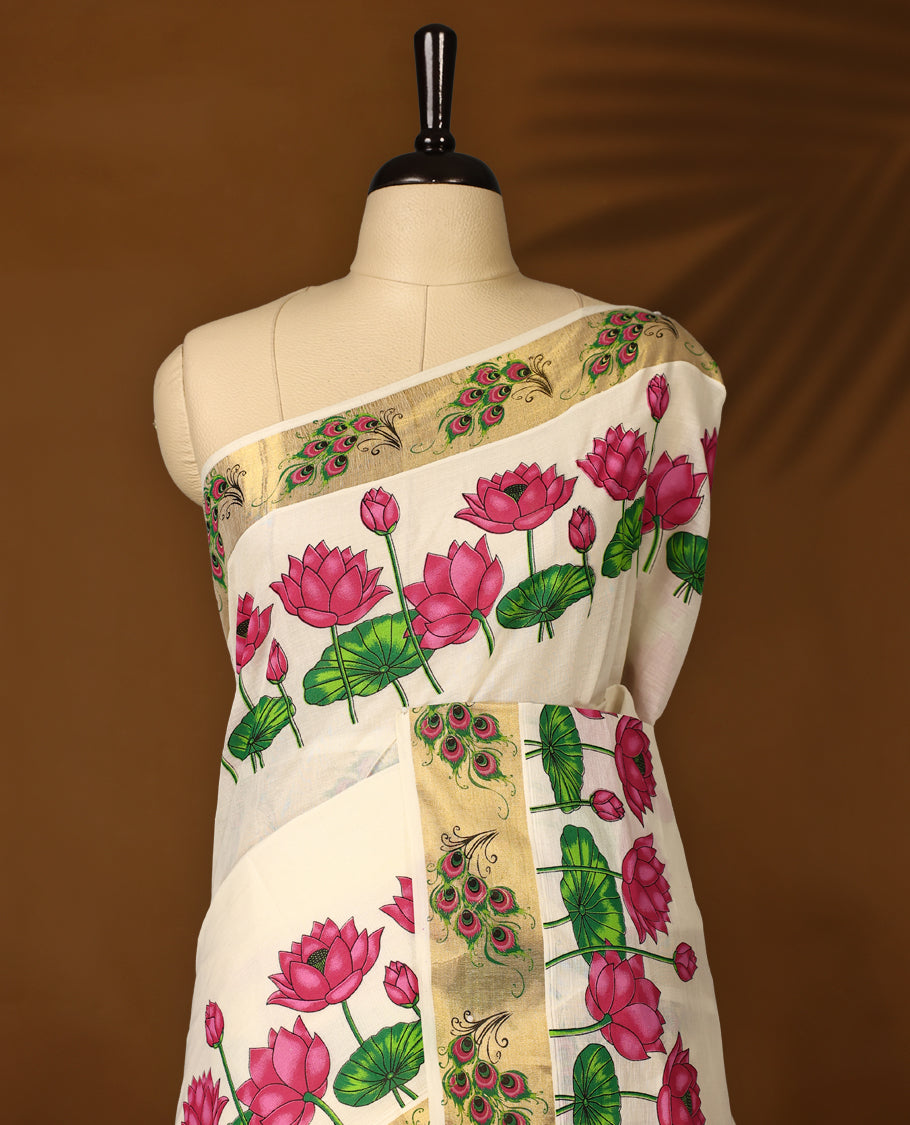 Elegant off white Kerala cotton saree with vibrant pink lotus digital prints and a rich golden zari border. Perfect blend of tradition and charm, paired with a matching blouse piece for a complete look.