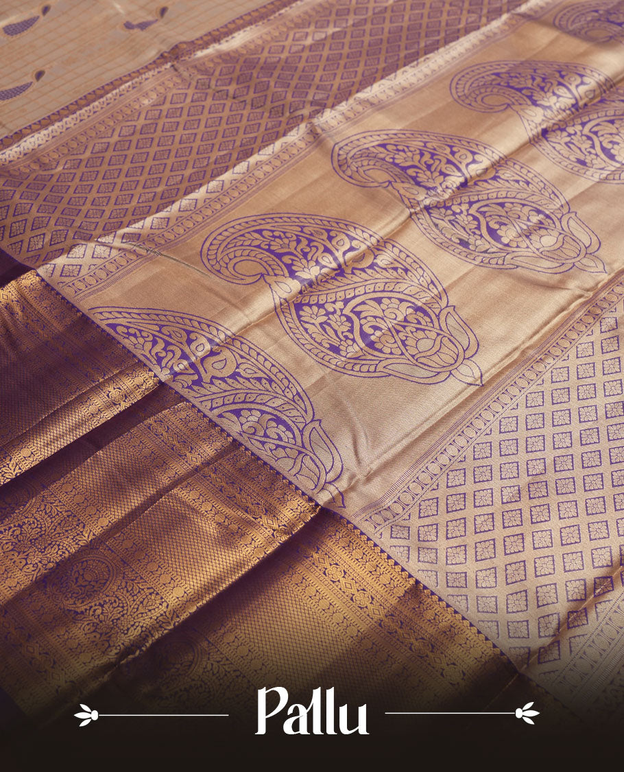 Cream Silk Saree with Purple & Gold Zari Checkered Grid Body, Textured Oval Buttas, Elegant Decorative Pallu Border, Grand Pallu with Ornate Peacock and Floral Motifs in Purple and Gold Tones, and Matching Purple Blouse.
