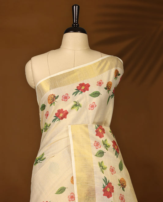 Elegant off white colour tissue Kerala saree with vibrant floral prints and a shimmering golden zari border, Lightweight and graceful, perfect for festive or traditional occasions & Includes matching blouse piece.