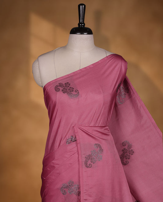 Pink colour semi soft silk saree adorned with delicate woven floral motifs on the body, complemented by a Self colour woven pallu with intricate detailing and tassel accents without border & Comes with a matching blouse piece.
