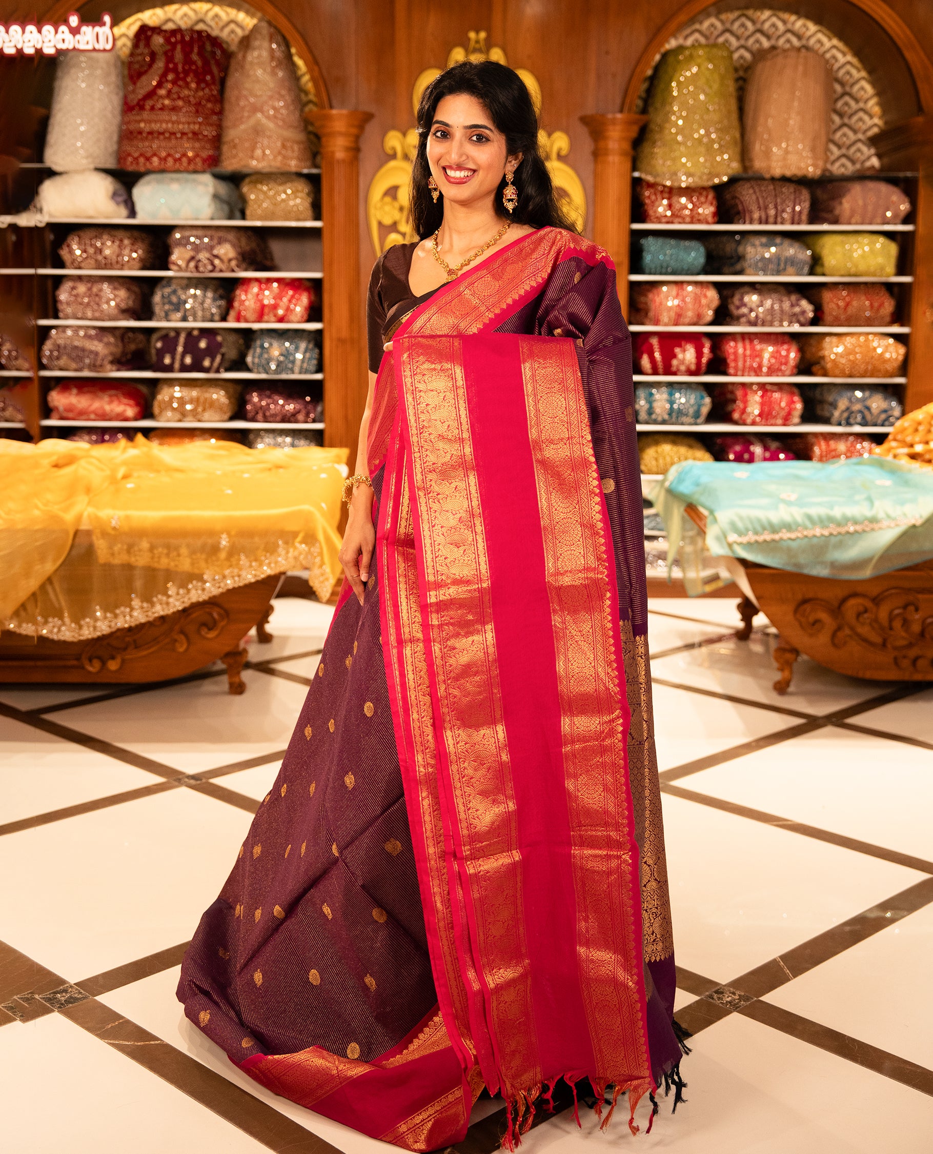 Purple with Magenta Chettinad cotton saree featuring Gold zari strips with peacock motifs on body, complemented by contrast colour border with zari design & grand pallu, comes with matching blouse piece.