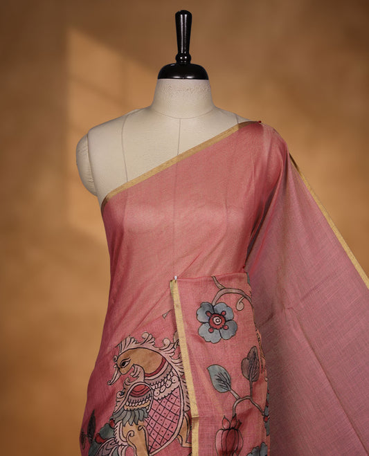 Georgia peach colour colour semi linen saree featuring hand-painted bird and floral motifs on the body, finished with a subtle gold border and paired with a matching floral print blouse.