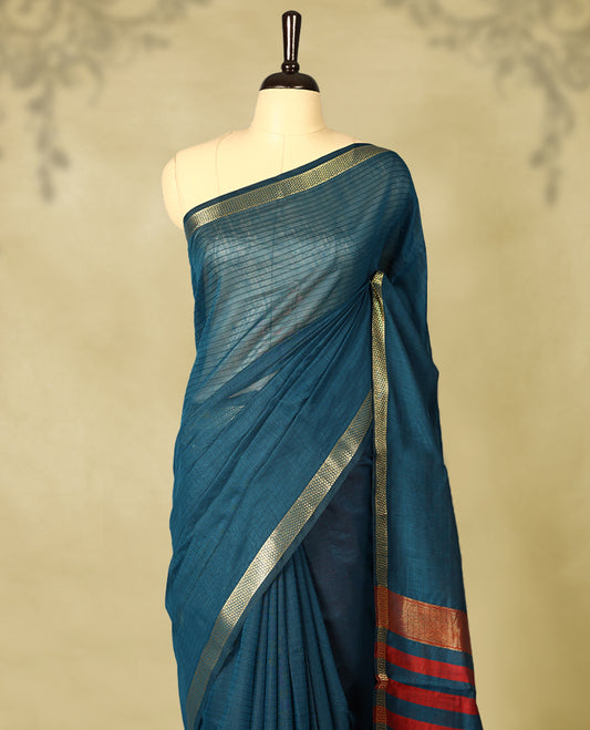 Deep Teal colour chanderi cotton saree with fine striped body, mangalgiri border, grand pallu featuring Maroon and gold zari stripes, with matching blouse.