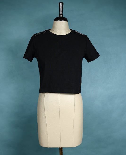 Black short sleeve T shirt with a round neck, featuring subtle stud detailing on the shoulders for a sleek, edgy twist on everyday comfort.