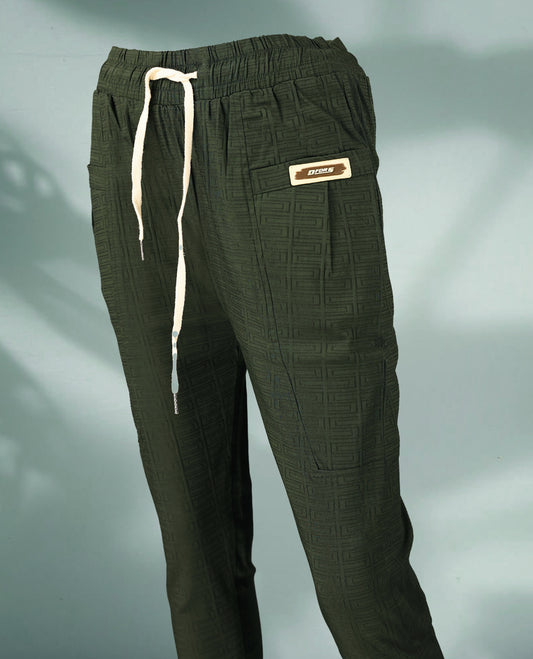 Deep Olive green colour jogger style pants crafted from textured fabric, featuring a drawstring waistband, patch pockets, and a sporty label detail