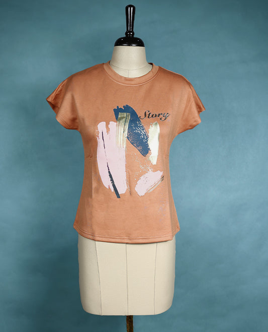 Peach toned T shirt with cap sleeves, featuring bold abstract paint style strokes in pastel and metallic hues for an artistic and modern flair.