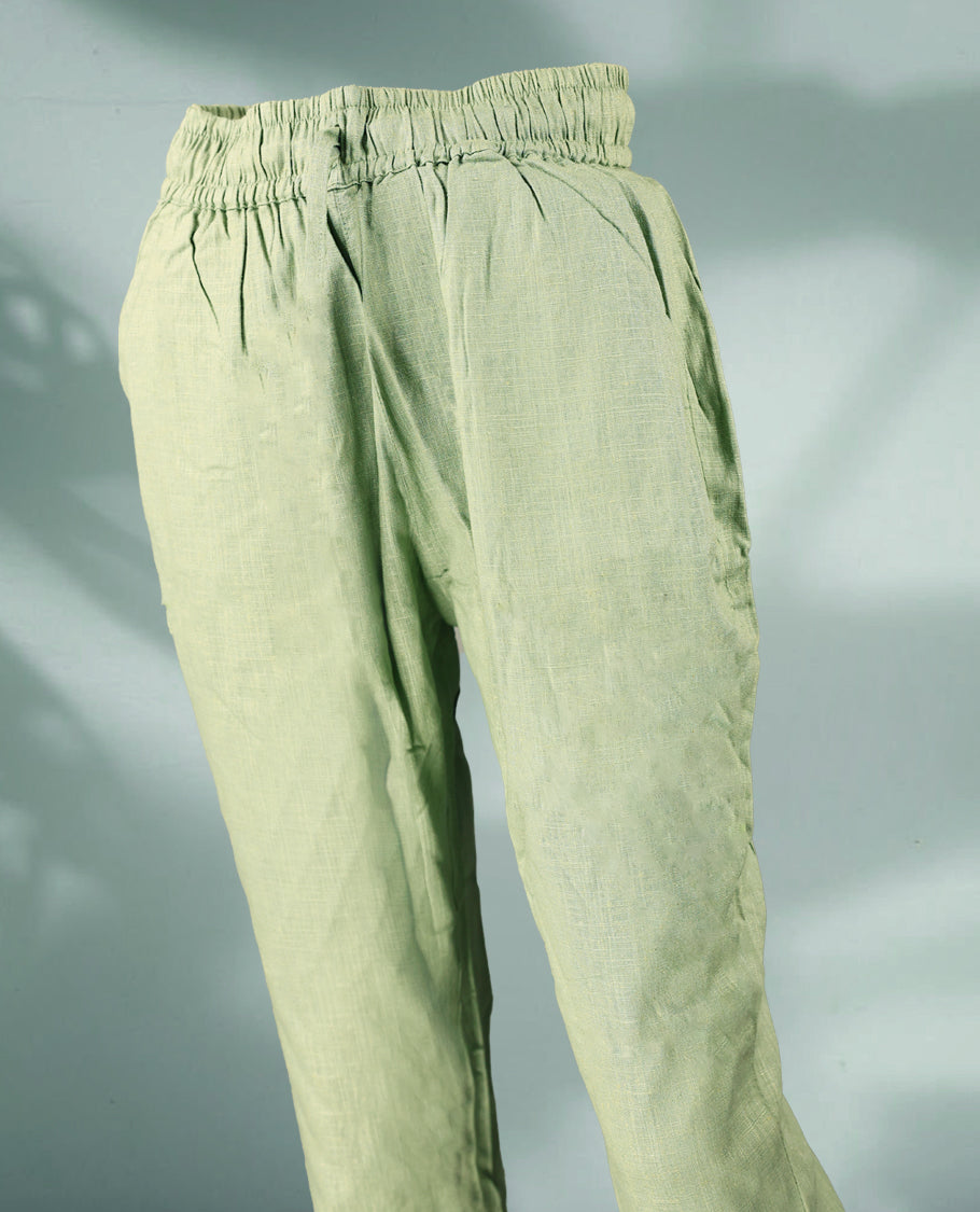 Light green colour women's pants feature a breathable textured fabric with a relaxed fit, elastic waistband, and drawstring closure