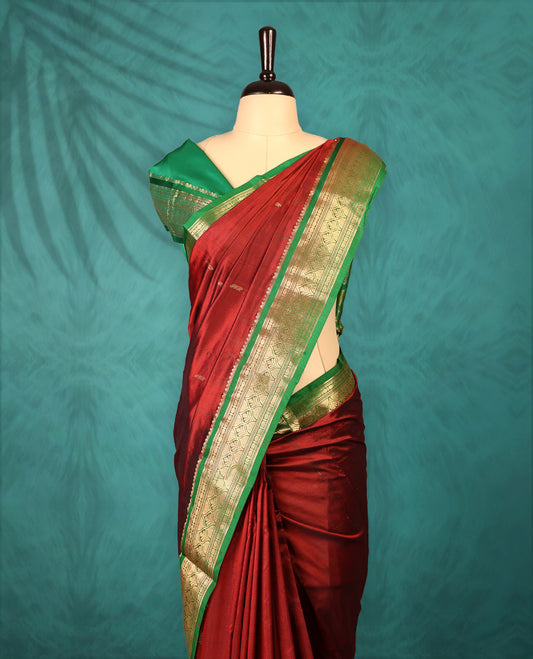 Maroon colour Traditional Kancheepuram Silk saree with small gold motifs on body, Green traditional border with intricate gold zari weaving, grand zari pallu, perfect for Bharatanatyam, with matching blouse.