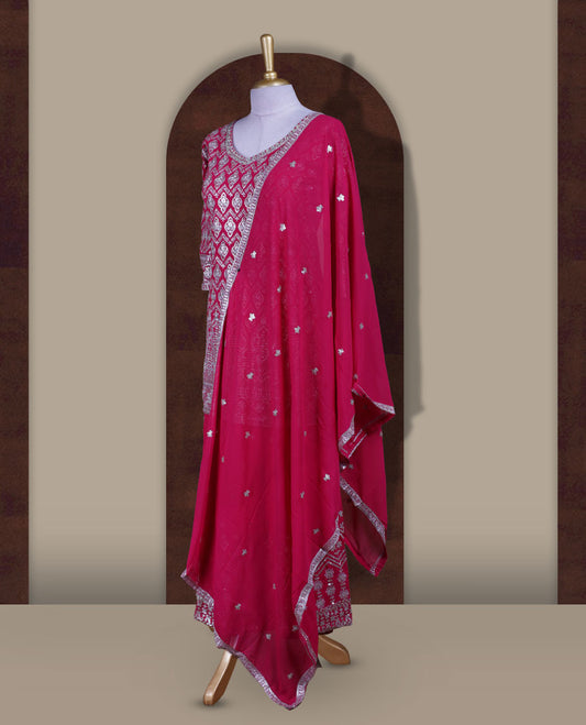 Elegant Magenta colour sharara set featuring a beautifully embroidered top with intricate silver and stone detailing, paired with a flowy flared bottom and a matching dupatta adorned with delicate sequin work.