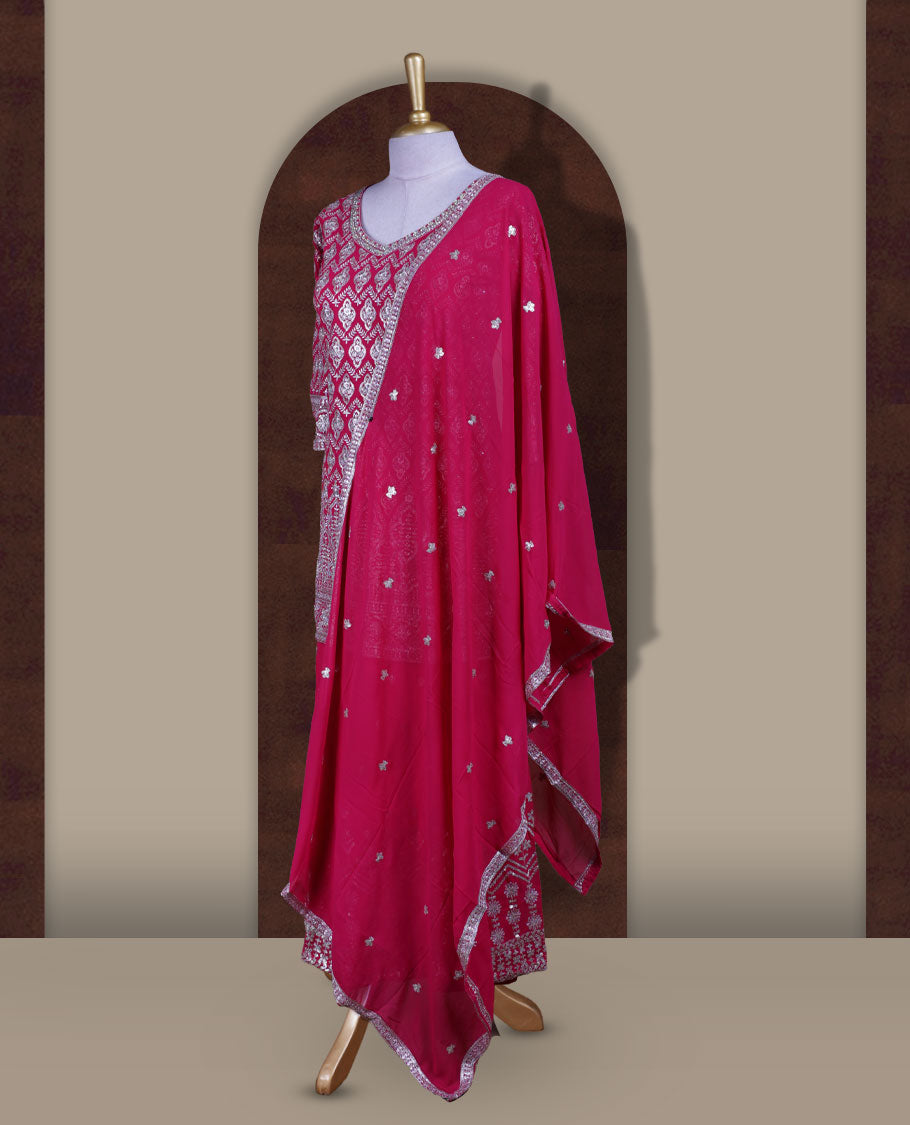 Elegant Magenta colour sharara set featuring a beautifully embroidered top with intricate silver and stone detailing, paired with a flowy flared bottom and a matching dupatta adorned with delicate sequin work.
