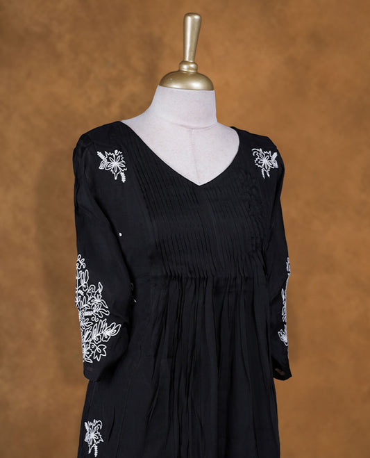 Black colour kurti with white colour colour thread pattern across the body, knee length design, styled with a V neckline and a  sleeve .