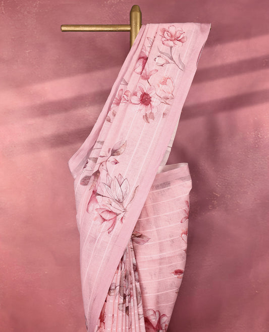 Rose pink colour pure linen saree featuring elegant floral digital prints across the body with subtle woven stripes adding a soft texture, complemented by a simple solid border pairs beautifully with a matching blouse.
