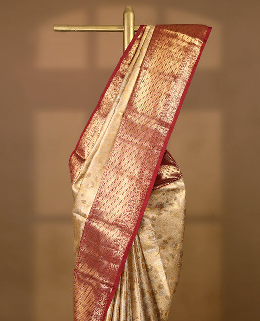 Gold colour tissue brocade saree with gold and silver zari floral kodi design on body, gold zari traditional floral and peacock work Maroon border, rich matching pallu with Antique zari motifs, paired with matching blouse.