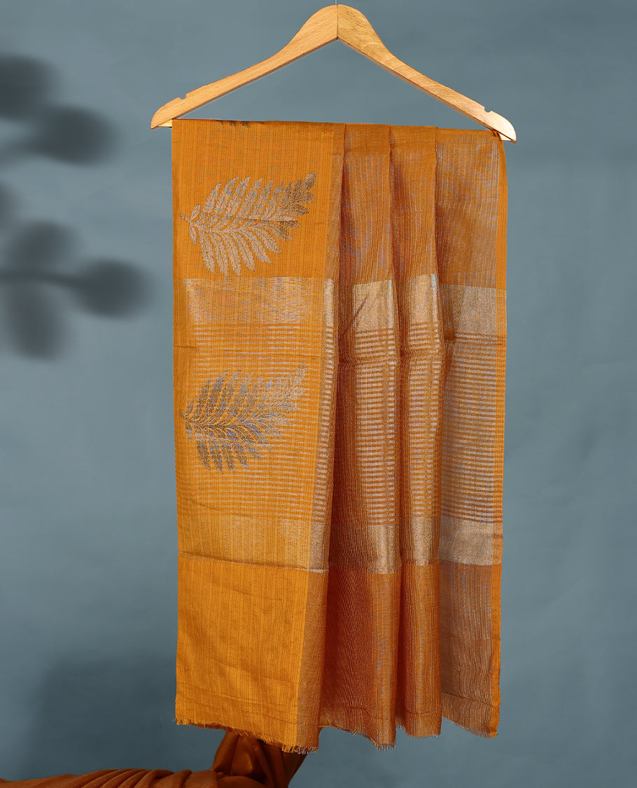 Mustard Colour Semi Tussar Silk saree featuring golden zari horizontal lines across the body, adorned with bold Leaf motifs on the border, paired with a matching blouse.