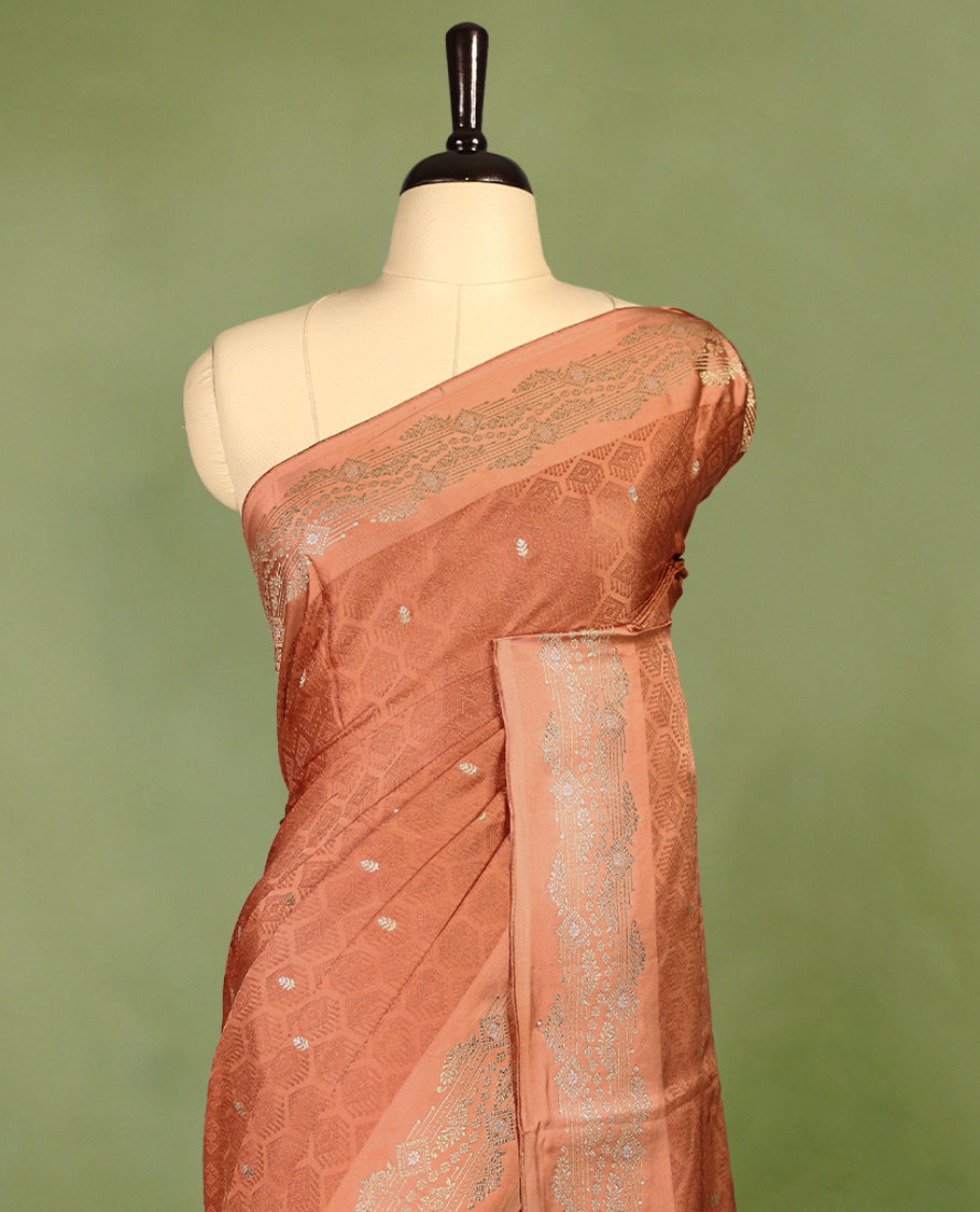 Pastel Brown colour pure Banaras crepe saree showcases elegant Gold & Silver zari Motifs all over the body, a traditional gold & Silver zari border, a rich intricately woven pallu, and comes with a matching blouse.