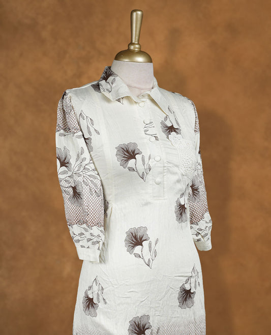 Ivory floral printed shirt dress with collared neckline, half button placket, lace-appliqué detail on chest, three-quarter sleeves, and scalloped hemline.