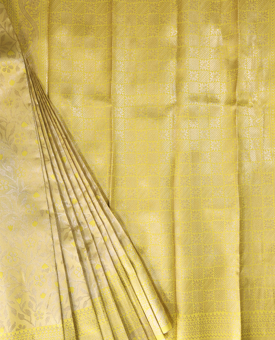 Pastel Yellow Semi tissue saree featuring a brocade body, self coloured zari border, and a matching self coloured blouse.