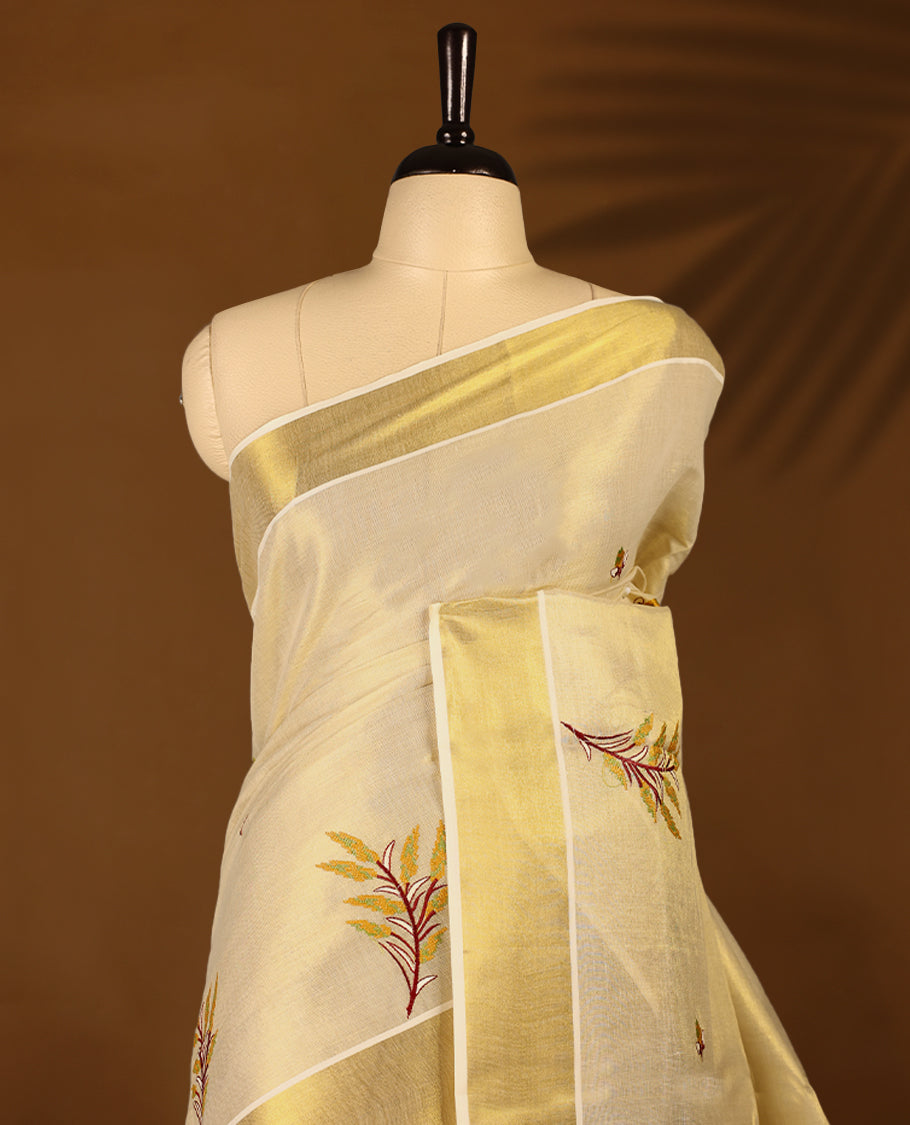 Light Gold colour Tissue Kerala saree featuring nell Kthir embroidery motifs on the body and a beautifully woven Gold Kasavu border, paired with a matching blouse perfect for festive occasions.