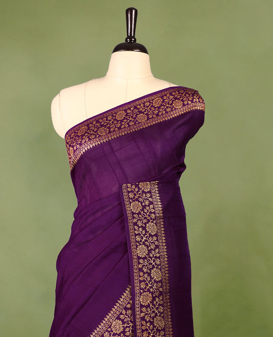 Purple colour Tussar Banaras saree featuring a plain body, rich floral woven zari border and grand pallu, paired with a matching blouse for an elegant and regal traditional look.
