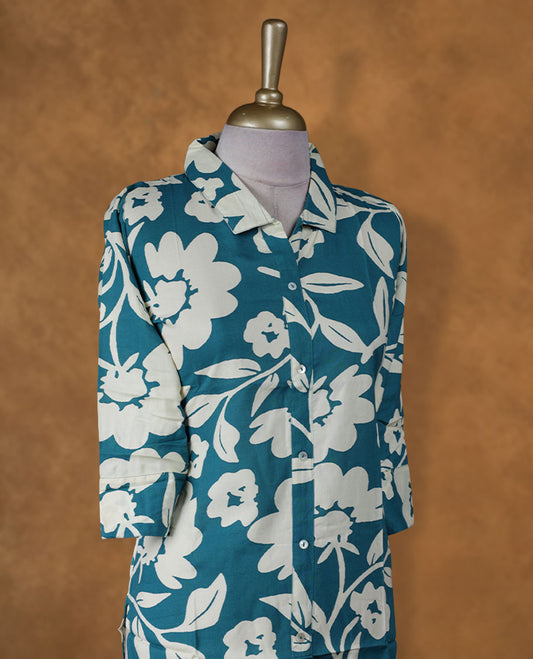 Teal floral printed medium-length kurti with collared neckline, three-quarter sleeves, and front button placket