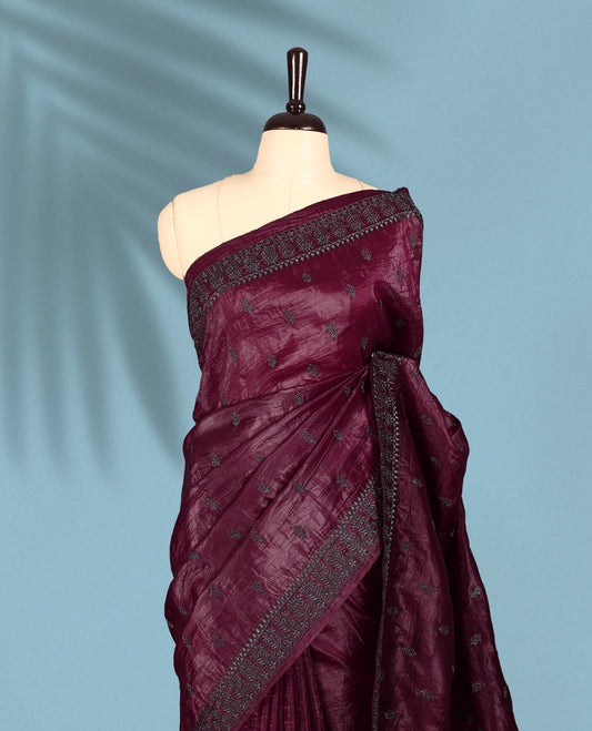 Maroon Colour crush soft silk saree, textured body with a natural crinkled finish, adorned with intricate Silver colored floral Motifs and complemented by a delicate Silver Zari embroidery border, paired with a matching blouse