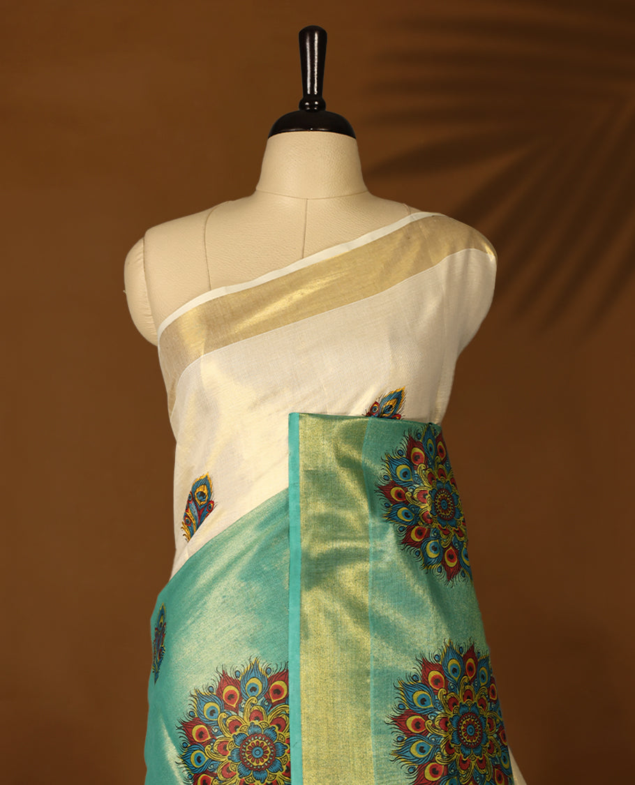 Pastel Green & Light Gold colour Tissue Kerala saree featuring Bold Floral Printed body and traditional golden zari kasavu border offering a classic and graceful look, paired with a matching blouse.
