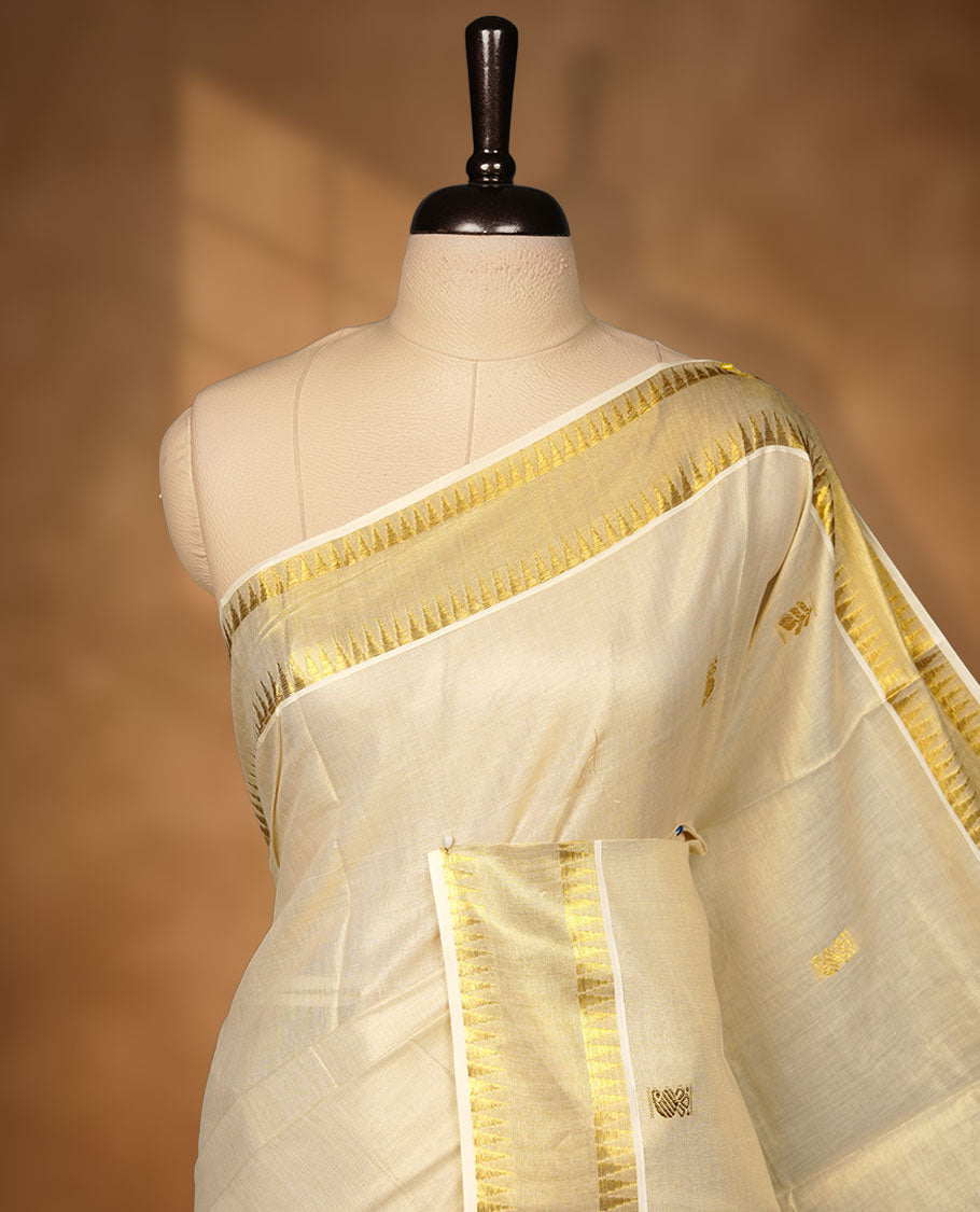 Elegant off-white Kerala saree featuring subtle gold zari buttas across the body, a refined kasavu border with traditional detailing, and a richly woven pallu, paired with a matching blouse