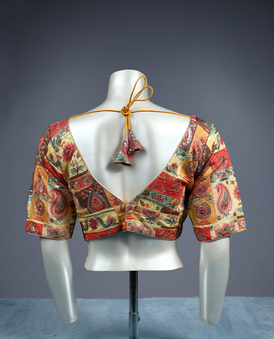 Multicolour, deep V neckline and 2/4th sleeves, adorned with vibrant Kalamkari style patchwork design, padded readymade blouse.