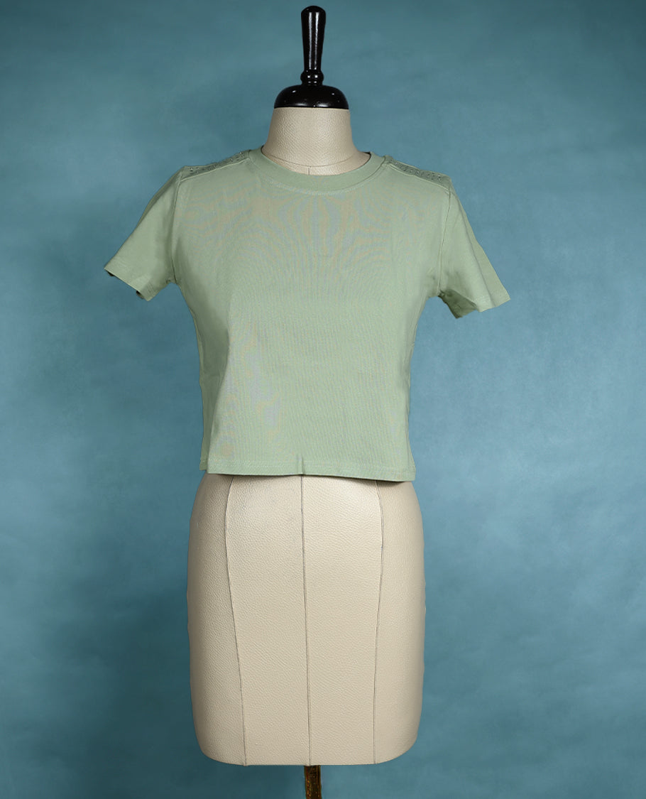 Pastel Green short sleeve T shirt with a round neck, featuring subtle stud detailing on the shoulders for a sleek, edgy twist on everyday comfort.