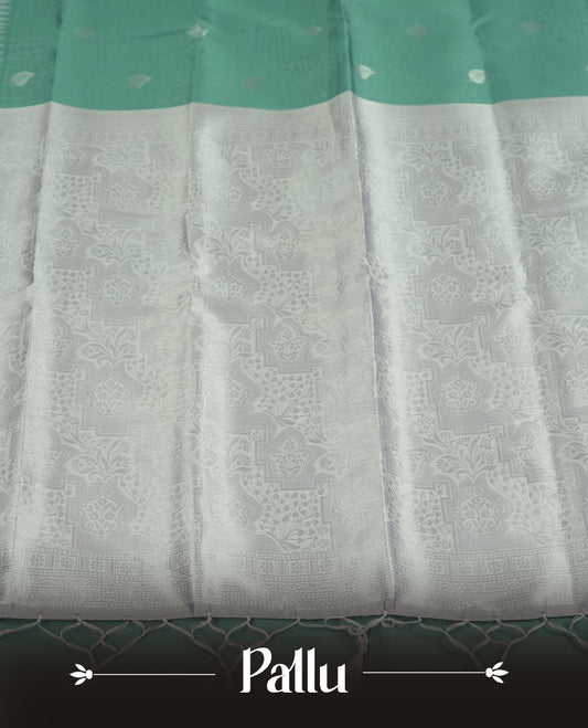 Sea Green colour Semi Silk Saree with Subtle Zari Butta Motifs on the Body, Contrasting Silver Zari Woven Pallu and Border with Intricate Patterns and Tassels, Paired with Coordinated Blouse Piece
