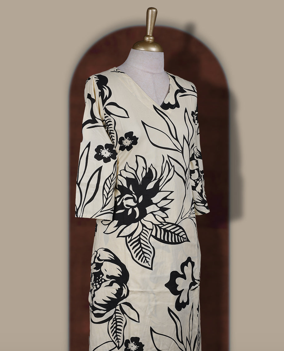 Ivory colour coord set with bold black floral prints, featuring a V neck and 3/4 sleeves, Paired with matching straight pants, it blends elegance and comfort for a chic everyday or casual outing look.