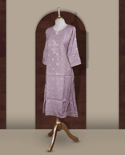 Soft Lavender colour Kurti adorned with all over Gold colour floral Block prints, featuring a straight cut kurta with round neckline and 3/4th sleeves.
