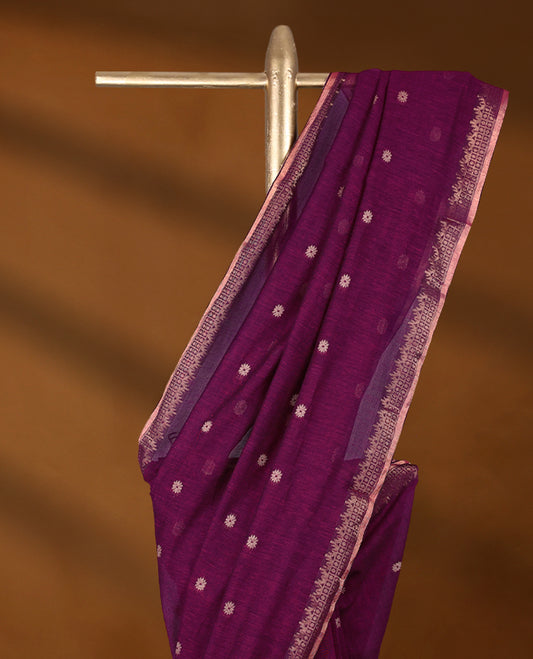Magenta colour soft khadi cotton saree with small Beige Zari Flower motifs on the body, detailed woven Gold zari border, paired pallu with tussles, with matching blouse.
