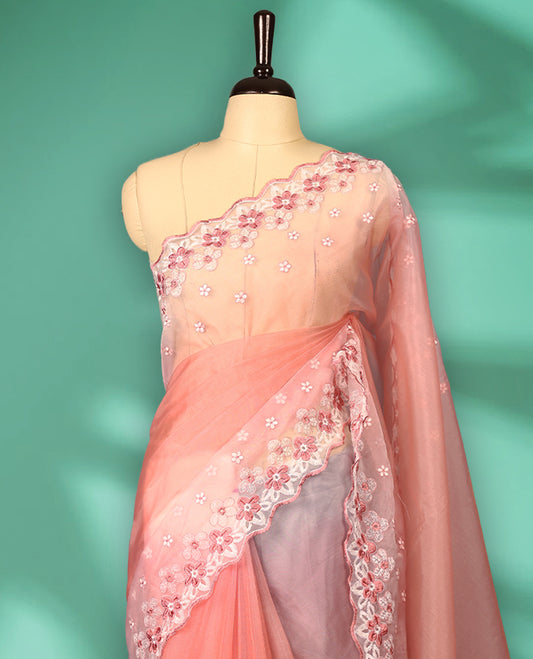 Peach and White colour double shade organza saree with delicate floral embroidery on body, intricately embroidered scallop border, floral embroidered design on pallu, with matching blouse