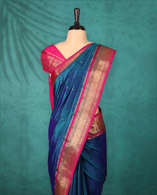 Peacock Blue colour Traditional Kancheepuram Silk saree with small gold motifs on body, Magenta traditional border with intricate gold zari weaving, grand zari pallu, perfect for Bharatanatyam, with matching blouse.