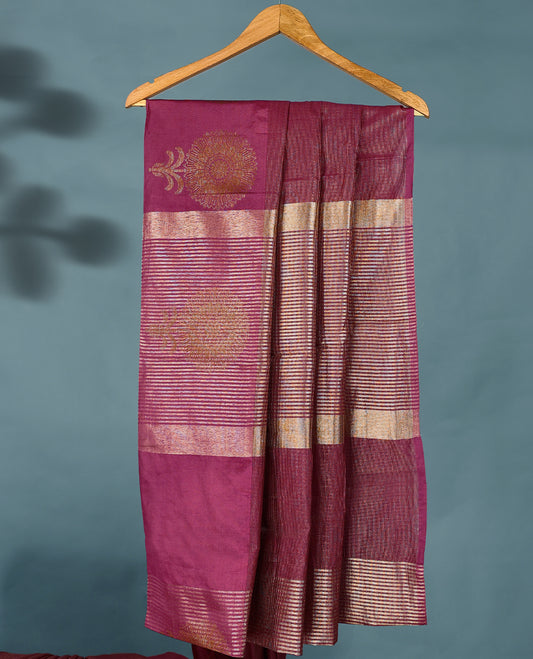 Dark Onion Pink Colour Semi Tussar Silk saree featuring golden zari horizontal lines across the body, adorned with bold Floral motifs on the border, paired with a matching blouse.