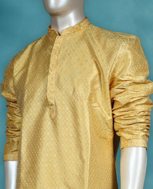 Yellow colour semi silk partywear kurta set featuring self colour thread and sequin work on the body, full sleeves, and paired with a matching bottom.
