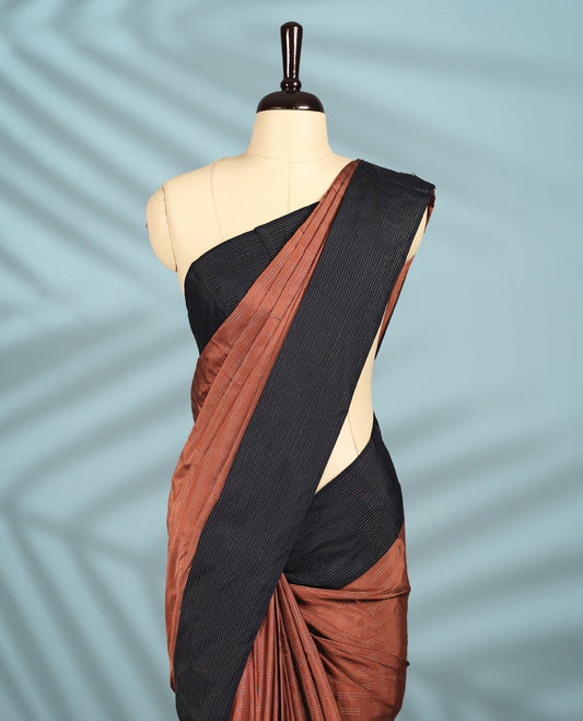 Rich chocolate brown Colour semi silk saree features elegant golden zari check patterns, beautifully contrasted by a sleek black border, and comes with a matching blouse.