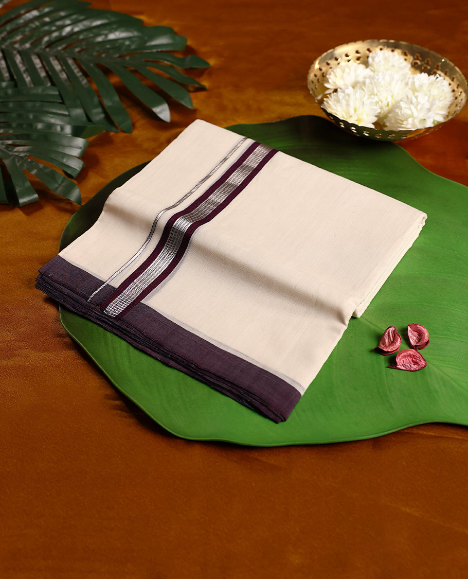 Elegant off white colour handloom pure cotton double dhoti adorned with a rich grape border highlighted by silver stripe detailing, offering a refined and traditional appeal.