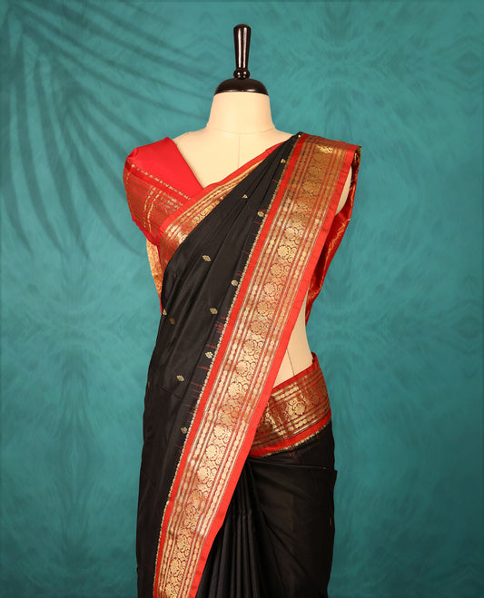 Black colour Traditional Kancheepuram Silk saree with small gold motifs on body, Rich red traditional border with intricate gold zari weaving, grand zari pallu, perfect for Bharatanatyam, with matching blouse.