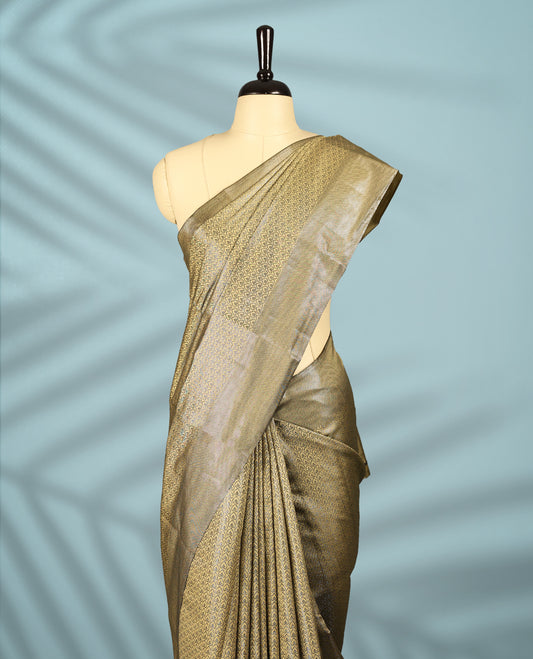 Pastel Gold Colour semi silk saree featuring an intricate Zari  motif weave across the body, paired with a zari worked border with matching blouse.