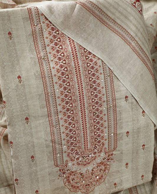 Beige colour churidhar material adorned with subtle printed motifs and sequin highlights, paired with a plain matching bottom and a printed dupatta.