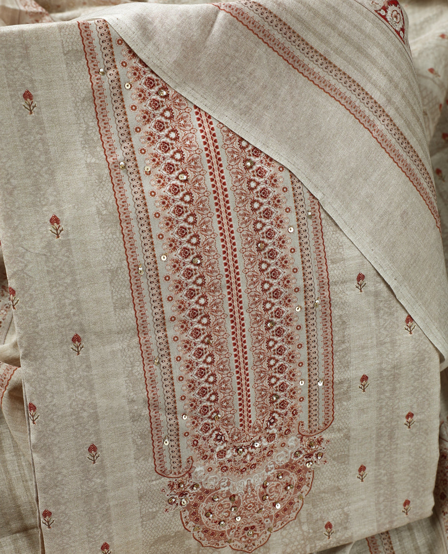 Beige colour churidhar material adorned with subtle printed motifs and sequin highlights, paired with a plain matching bottom and a printed dupatta.