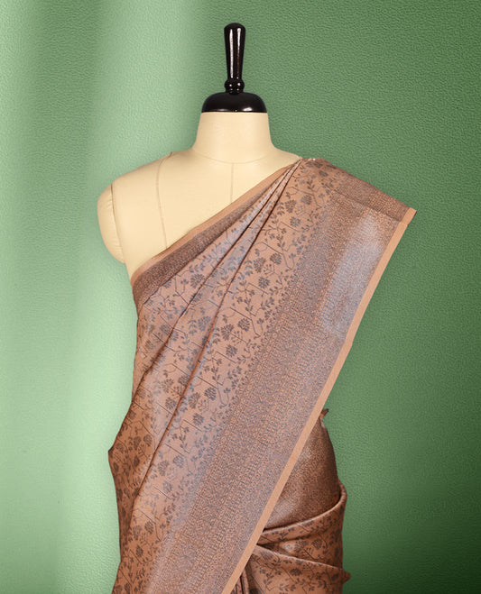 Light Pastel peach colour semi silk saree featuring neem zari floral kodi motifs all over the body, complemented by a rich self colour woven border, with matching blouse.