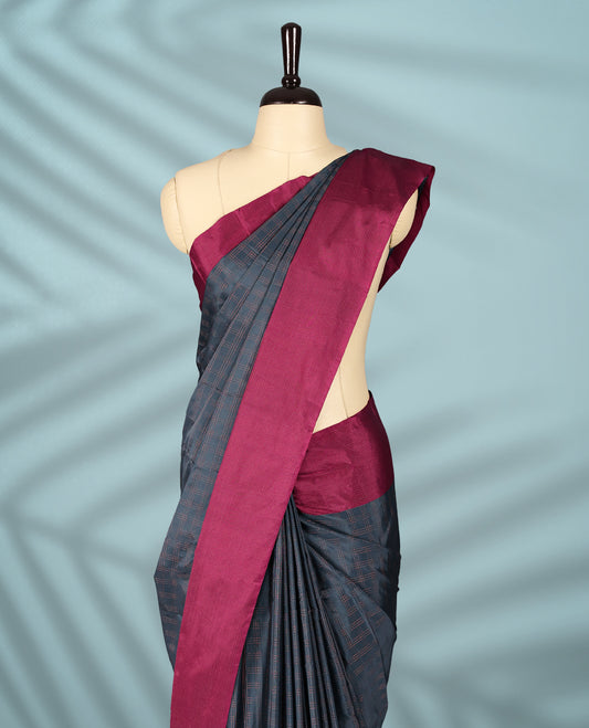Deep Grey Colour semi silk saree features a fine checked body design, complemented by a rich Wine border, and comes with a matching blouse.