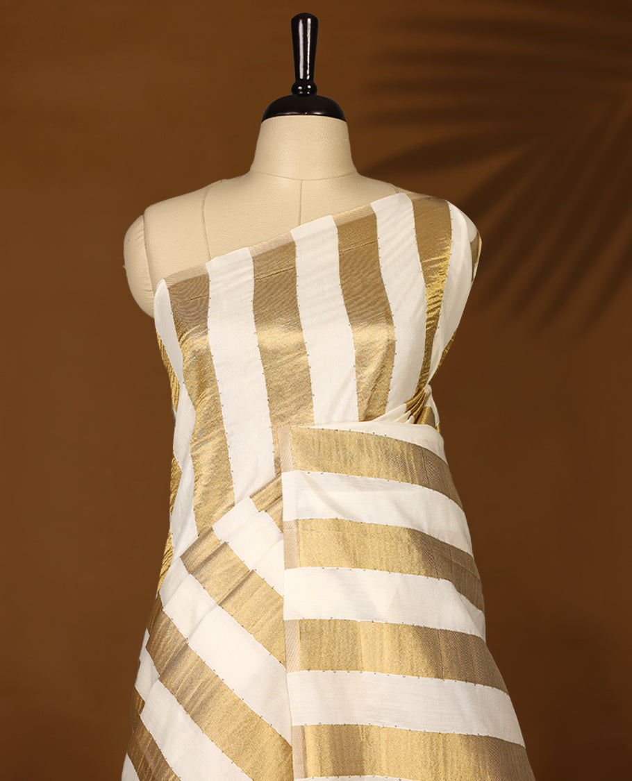 Elegant white colour sotf  Tussar Kerala saree featuring Gold Zari Bold stripes on body, Rich Pallu, Paired with matching blouse offering a classic and graceful look