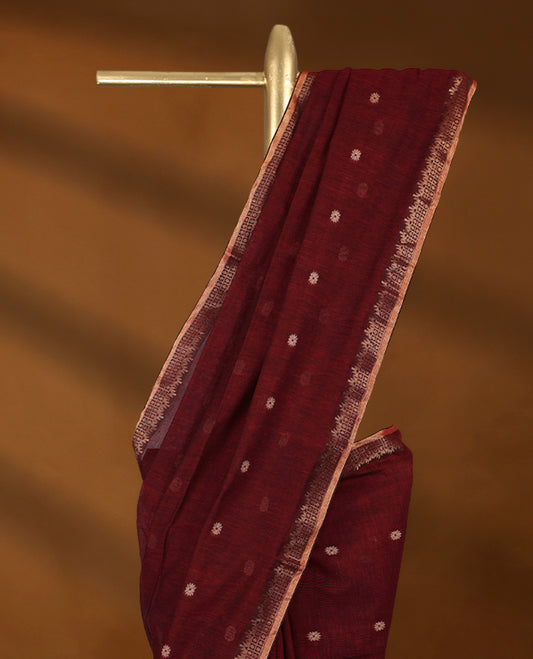 Maroon colour soft khadi cotton saree with small Beige Zari Flower motifs on the body, detailed woven Gold zari border, paired pallu with tussles, with matching blouse.