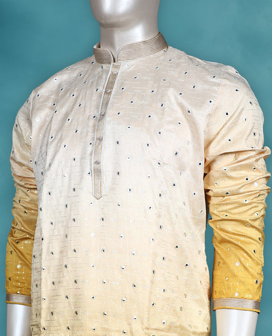 Ivory to yellow ombre semi silk kurta set featuring self colour thread and sequin work on the body, full sleeves, and paired with a matching bottom.